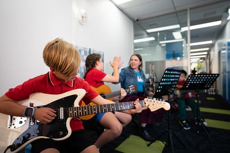 Guitar Bassie hair, hi five in bg Guitar