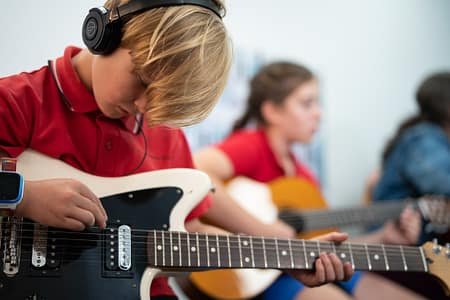 Guitar Bassie w electric anad headphones Guitar